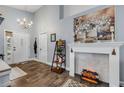 Cozy living room features a decorative fireplace, high ceilings, and a well-lit entrance with tiled floors at 116 Douglas St, Edgewater, FL 32141