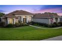 Charming one-story home with a manicured front yard, lush landscaping and walkway to a covered front porch at 16344 Magnolia Bluff Dr, Montverde, FL 34756