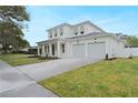 Well-manicured lawn and driveway leading up to the two-car garage of this two-story home at 2248 Middleton Ave, Winter Park, FL 32792