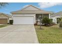 Inviting single-story home with a two-car garage, screened porch and mature landscaping at 25239 Cranes Roost Cir, Leesburg, FL 34748