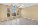 Bright bedroom with a large window, ceiling fan, and tile flooring for a clean and modern look at 3001 Bellingham Dr, Orlando, FL 32825