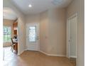 Bright foyer with tile flooring, decorative front door, and an arched doorway at 321 Davinci Pass, Kissimmee, FL 34759
