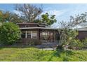 Classic home with a large lawn and a screened-in porch, perfect for enjoying the outdoors at 425 S Woodland St, Winter Garden, FL 34787