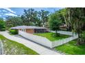 Brick home with a fenced backyard and screened porch, offering privacy at 5584 N Dean Rd, Orlando, FL 32817