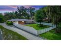 Brick home with a fenced backyard and screened porch, offering privacy at 5584 N Dean Rd, Orlando, FL 32817