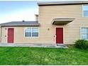 The exterior features a red front door, well-kept lawn, and classic siding, enhancing curb appeal at 601 Washington Palm Loop, Davenport, FL 33897