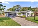 Charming single-story home with a brick driveway and manicured lawn at 615 Pershing Dr, Altamonte Springs, FL 32701