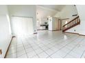 Bright living room featuring tile floors, high ceilings, and natural light from the sliding glass doors at 7440 Windsome Ct, Orlando, FL 32810
