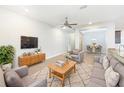 Inviting living room boasts a ceiling fan and an adjacent dining area, perfect for entertaining at 947 Cumberland Dr, Kissimmee, FL 34759