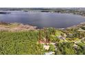 Gorgeous lakefront property featuring mature trees and private access to pristine lake, marked by a red border at 10433 Trout Rd, Orlando, FL 32836