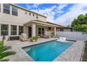 Beautiful backyard showcasing a pool, patio, outdoor seating area, and well-maintained landscaping at 1077 Fountain Coin Loop, Orlando, FL 32828