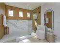 Beautiful bathroom with glass shower enclosure, wood plank walls and modern fixtures at 1077 Fountain Coin Loop, Orlando, FL 32828