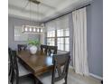 Cozy dining area with a large window, modern lighting fixture, and seating for six at 1077 Fountain Coin Loop, Orlando, FL 32828