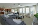 Open-concept living room and kitchen area, filled with natural light from the multiple windows at 1077 Fountain Coin Loop, Orlando, FL 32828