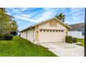 Detached two-car garage showcasing ample parking and a tidy lawn at 11320 Pink Blossom Ct, Orlando, FL 32821