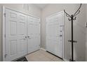 Bright entryway with tile floors, coat rack, and closet for organized storage at 1357 Venezia Ct # 402, Davenport, FL 33896