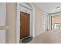 Condo hallway with door 402, neutral walls and an 'Exit' sign visible towards the outdoor area at 1357 Venezia Ct # 402, Davenport, FL 33896