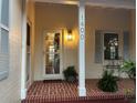 A lovely close-up of the front porch, highlighting the brick floor and front door at 1400 Tedford St, Eustis, FL 32726