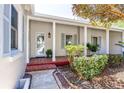 Charming front porch with brick accents, columns, and a well-maintained garden at 1400 Tedford St, Eustis, FL 32726
