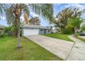 Charming single-story home featuring a well-manicured lawn, a one car garage, and a welcoming entrance at 1967 Villa Angelo Blvd, St Cloud, FL 34769