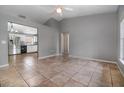 Open-concept living room showcasing tile flooring and access to the kitchen, enhancing the home's appeal at 1967 Villa Angelo Blvd, St Cloud, FL 34769
