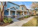 Attractive townhomes featuring stone accents, covered porches, and manicured landscaping at 2478 Pillar Coral Dr # S, Orlando, FL 32808