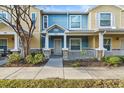 Inviting townhome featuring a covered front porch and colorful exterior paint scheme at 2478 Pillar Coral Dr # S, Orlando, FL 32808