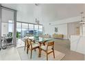 Dining area with a glass table and large windows offering natural light and scenic views at 260 S Osceola Ave # 601, Orlando, FL 32801