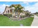 Beautiful home with a landscaped lawn and a cozy front porch area with rocking chairs at 2741 Southland St, St Cloud, FL 34772