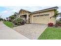 Street view of an inviting home featuring an attached two car garage and a manicured front lawn at 2741 Southland St, St Cloud, FL 34772