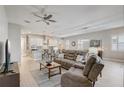 Open-concept living room with modern furnishings, a ceiling fan, and lots of natural light at 2741 Southland St, St Cloud, FL 34772