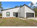 The front exterior of a modern single story home, featuring crisp white walls and modern design elements at 3995 Sw 151 Street, Ocala, FL 34473