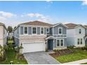 Inviting two-story home features a stone facade, lush lawn, and a charming covered entryway at 4149 Lana Ave, Davenport, FL 33897