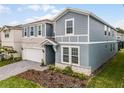 Beautiful two-story home showing the exterior elevation, landscaping and welcoming entryway at 4149 Lana Ave, Davenport, FL 33897
