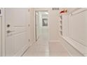 Functional mudroom hallway with built-in storage and neutral tile flooring, combining convenience with clean design at 4149 Lana Ave, Davenport, FL 33897