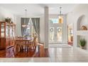 Elegant dining room featuring a display cabinet, chandelier, and sun-filled windows at 4263 Lillian Hall Ln, Orlando, FL 32812