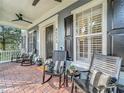 Expansive front porch with relaxing seating, ceiling fan, and classic architectural charm at 4533 Burke St, Orlando, FL 32814