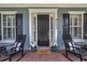 Inviting front porch featuring rocking chairs, a welcome mat, and decorative potted plants at 4533 Burke St, Orlando, FL 32814
