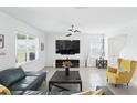 A cozy living room with neutral colors, bright light, and comfortable seating arrangement at 5226 Mahogany Dr, Mount Dora, FL 32757