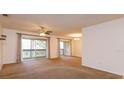 Bright living room with neutral carpet and a large sliding glass door leading to a balcony at 600 Northern Way # 404, Winter Springs, FL 32708