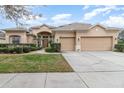 Charming single-story home with a well-manicured lawn and a spacious three-car garage at 6942 Remington View Ct, Orlando, FL 32829