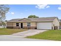 Lovely single-Gathering home featuring a two-car garage, a well-maintained lawn and driveway at 741 Maderia Ct, Kissimmee, FL 34758