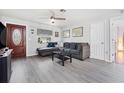 Inviting living room with gray floors, a comfortable sofa, and a cozy atmosphere at 741 Maderia Ct, Kissimmee, FL 34758