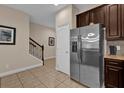 Hallway view features stainless steel refrigerator and staircase at 8201 Roseville Rd, Davenport, FL 33896