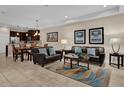 Open-concept living area features modern furnishings, neutral tones, and a seamless flow to the dining area at 8201 Roseville Rd, Davenport, FL 33896