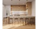 Modern kitchen featuring an island with seating, sleek cabinetry, and stylish pendant lighting at 8517 Karrer Ter, Orlando, FL 32827