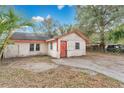 Exterior angle of a home with a concrete drive and compact yard, under a blue sky at 1014 24Th St, Orlando, FL 32805