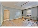 A living room with hardwood floors, a window, and an archway, awaiting renovation at 1014 24Th St, Orlando, FL 32805