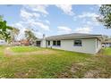 The backyard reveals a well-maintained lawn and a view of the home's exterior at 1038 E Hancock Dr, Deltona, FL 32725