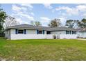 This attractive single-story home is set on a well-manicured lot with a front yard at 1038 E Hancock Dr, Deltona, FL 32725